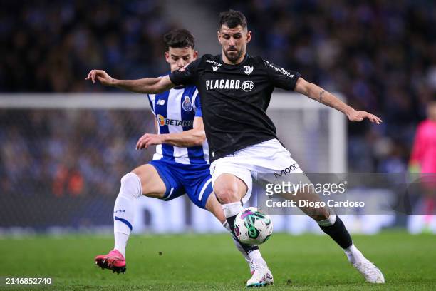 Ze Pedro of FC Porto and Nelson Oliveira of Vitoria Guimaraes battle for the ball during the Liga Portugal Bwin match between FC Porto and Vitoria...