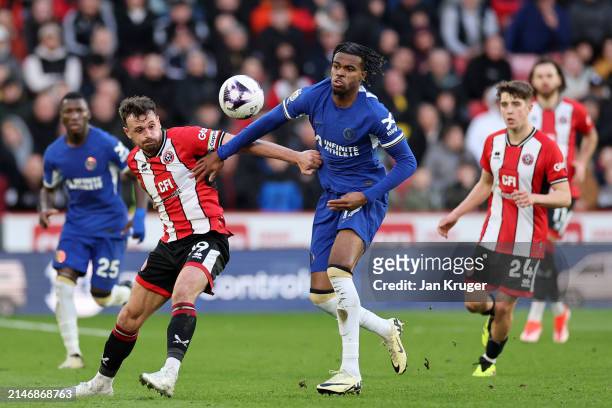 Carney Chukwuemeka of Chelsea battles with Jack Robinson of Sheffield United during the Premier League match between Sheffield United and Chelsea FC...