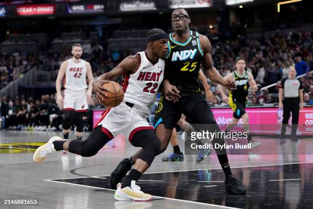 Jimmy Butler of the Miami Heat dribbles the ball while being guarded by Jalen Smith of the Indiana Pacers in the first quarter at Gainbridge...