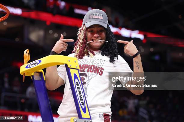 Te-Hina Paopao of the South Carolina Gamecocks cuts down the net after beating Iowa Hawkeyes in the 2024 NCAA Women's Basketball Tournament National...