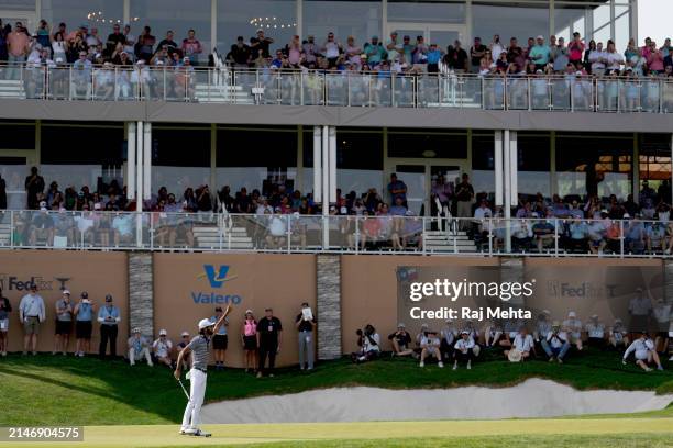 Akshay Bhatia of the United States celebrates after playing his putt shot on the 18th hole during the final round of the Valero Texas Open at TPC San...