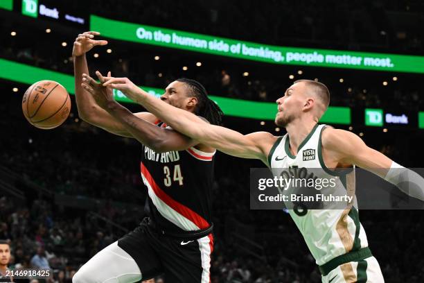 Kristaps Porzingis of the Boston Celtics fouls Jabari Walker of the Portland Trail Blazers during the first quarter at the TD Garden on April 07,...