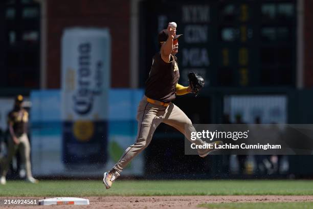 Ha-Seong Kim of the San Diego Padres throws to first base to get the out of Nick Ahmed of the San Francisco Giants in the bottom of the seventh...