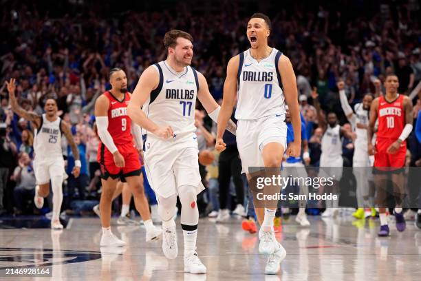 Dante Exum of the Dallas Mavericks celebrates with Luka Doncic after making a buzzer beater 3-pt basket to tie the game in the fourth quarter and...