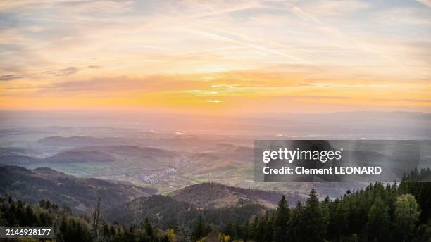 aerial view of the rhine plain with villages and agricultural fields, as seen from the summit of the blauen (hochblauen) at sunset with the sun setting behind the vosges mountains, black forest (schwarzwald) mountain range - baden-württemberg - germany. - lotharingen stockfoto's en -beelden