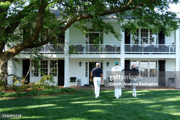 Tiger Woods leaves the course to enter the Clubhouse after practicing a few holes with Rob McNamara and caddie Lance Bennett prior to the 2024...