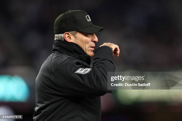 Umpire Angel Hernandez looks on during the second inning of the game between the New York Yankees and the Toronto Blue Jays at Yankee Stadium on...
