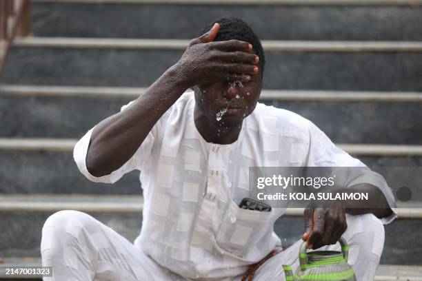 Man performs ablution before attending a special morning prayer to start the Eid al-Fitr festival, marking the end of the holy month of Ramadan at...