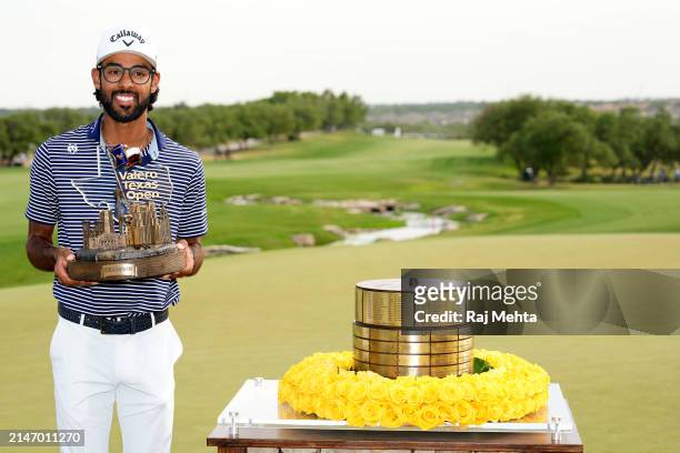 Akshay Bhatia of the United States poses with the trophy after winning the Valero Texas Open on the 18th hole of the first playoff during the final...