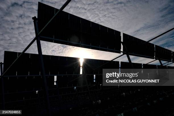 Fruit trees under an installation of photovoltaic panels on the Sun Agri site at the Rhone Alpes agrivoltaic experimental station in Etoile sur...