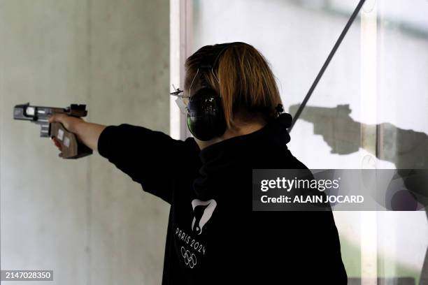 An athlete competes during the women 25 meters air pistol competition as part of a test event at the centre national de tir français , French...