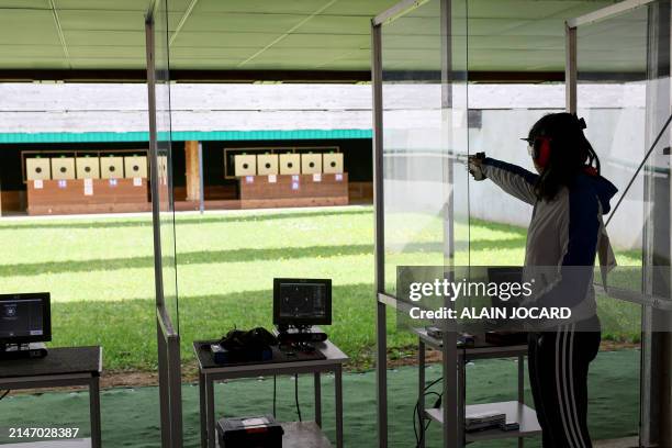 An athlete competes during the women 25 meters air pistol competition as part of a test event at the centre national de tir français , French...