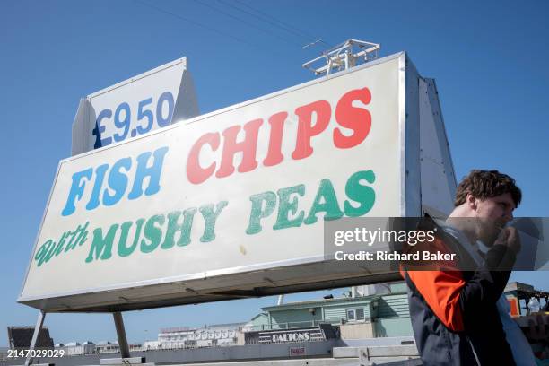 Fish and chips that comes with mushy peas sign is seen on the seafront, on 7th April 2024, in Brighton, England.