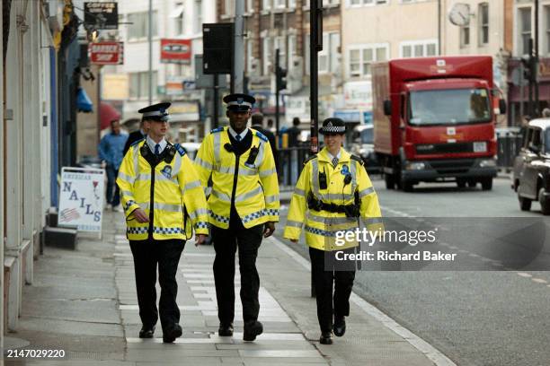 British Transport PCSOs patrol the streets around Kings Cross Station, on 25th June 2005, in London, England. Police Community Support Officers work...
