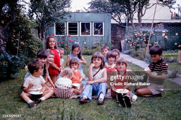 Vintage portrait of birthday party children, all growing up in the 1970s, on 1st July 1973 in Bristol, England.