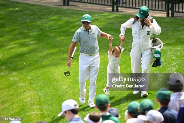 Rickie Fowler with his wife, Allison Stokke, swing their daughter, Maya, during the Par-3 Contest, prior to Masters Tournament at Augusta National...