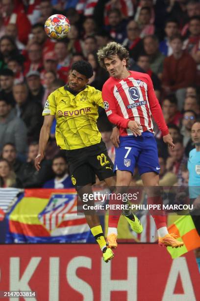 Dortmund's Dutch defender Ian Maatsen vies for a header with Atletico Madrid's French forward Antoine Griezmann during the UEFA Champions League...