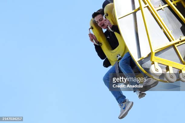 People enjoy the sunny day at an amusement park during the Eid al-Fitr holiday in Ankara, Turkiye on April 10, 2024. Those who spent the holiday in...