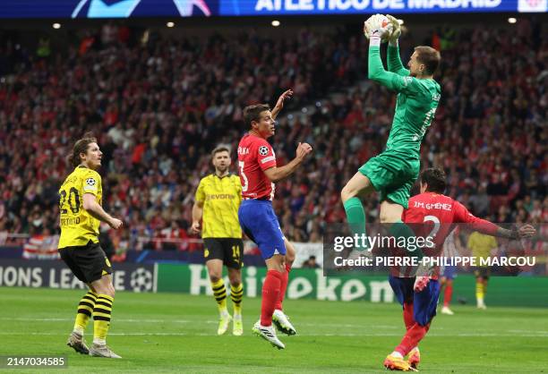Atletico Madrid's Slovenian goalkeeper Jan Oblak jumps for the ball during the UEFA Champions League quarter final first leg football match between...