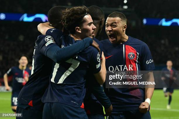 Paris Saint-Germain's French forward Kylian Mbappe celebrates after Paris Saint-Germain's French forward Ousmane Dembele scored an equalizer during...