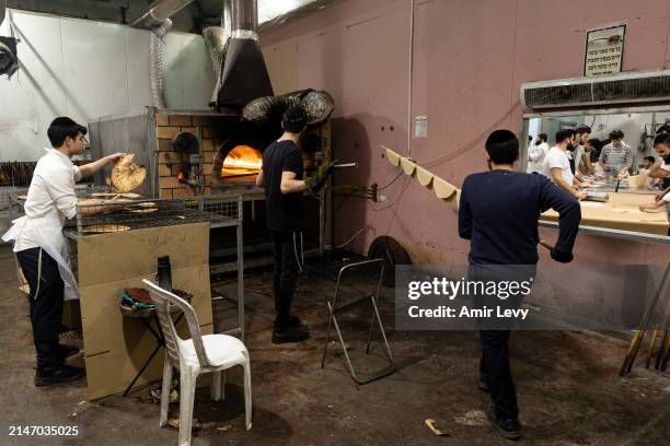 Jewish workers prepare a handmade matzahs at a bakery in the Southern city of Netivot on April 10, 2024 in Netivot, Israel. The bakery, located in...