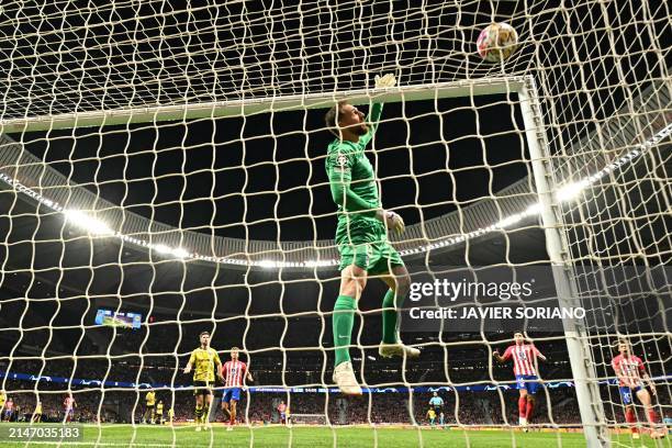 Atletico Madrid's Slovenian goalkeeper Jan Oblak jumps to make a saver during the UEFA Champions League quarter final first leg football match...