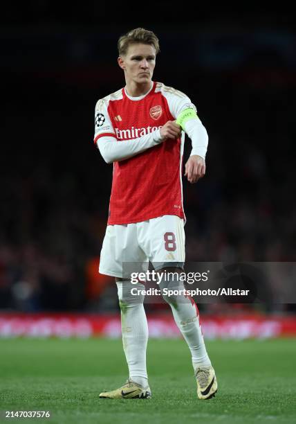 Martin Odegaard of Arsenal adjusts his captain's arm band during the UEFA Champions League quarter-final first leg match between Arsenal FC and FC...