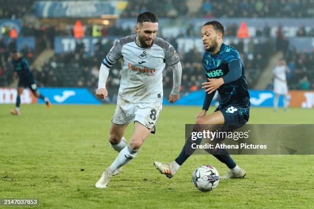 Matt Grimes of Swansea City and Lewis Baker of Stoke City in action during the Sky Bet Championship match between Swansea City and Stoke City at the...