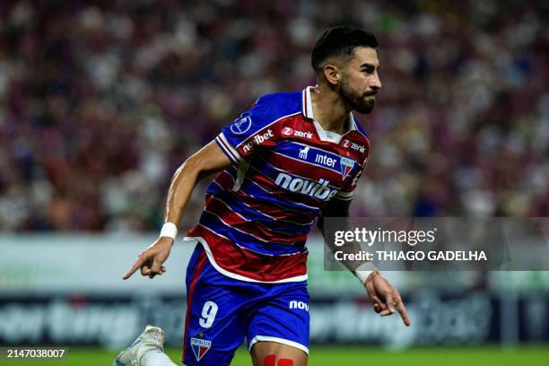 Fortaleza's Argentine forward Juan Martin Lucero celebrates after scoring during the Copa Sudamericana group stage first leg match between Brazil's...