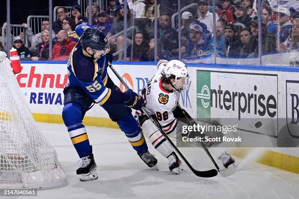 Colton Parayko of the St. Louis Blues defends against Connor Bedard of the Chicago Blackhawks on April 10, 2024 at the Enterprise Center in St....