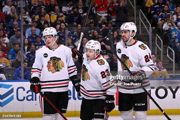 Philipp Kurashev of the Chicago Blackhawks is congratulated after scoring a goal against the St. Louis Blues on April 10, 2024 at the Enterprise...