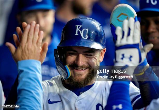 Kyle Isbel of the Kansas City Royals is congratulated by teammates after scoring a run during the third inning against the Houston Astros at Kauffman...