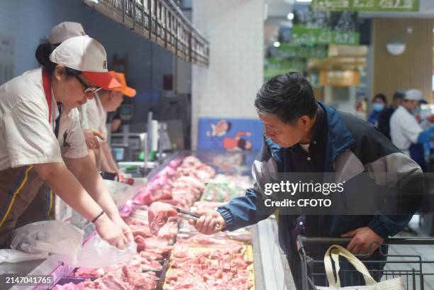 Customer shops at a supermarket in Hangzhou city, Zhejiang province, China, April 11, 2024. On the same day, data released by the National Bureau of...