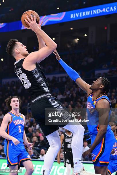 Zach Collins of the San Antonio Spurs shoots in the first half against the Oklahoma City Thunder at Paycom Center on April 10, 2024 in Oklahoma City,...