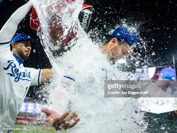 Vinnie Pasquantino of the Kansas City Royals is doused with water by MJ Melendez after defeating the Houston Astros at Kauffman Stadium on April 10,...