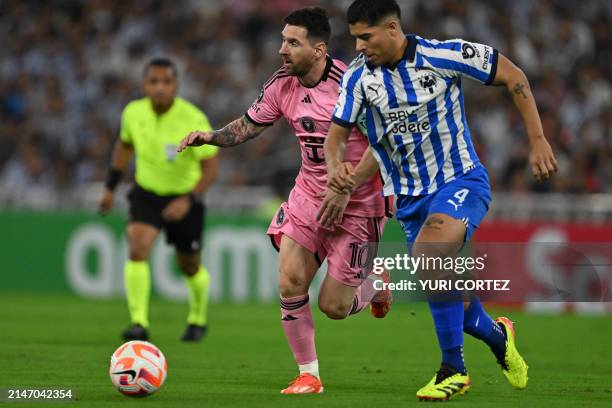 Inter Miami's Argentine forward Lionel Messi and Monterrey's defender Victor Guzman fight for the ball during the Concacaf Champions Cup...