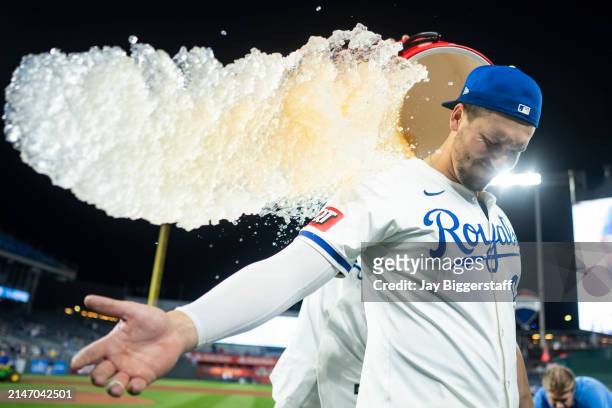 Vinnie Pasquantino of the Kansas City Royals is doused with water by MJ Melendez after defeating the Houston Astros at Kauffman Stadium on April 10,...