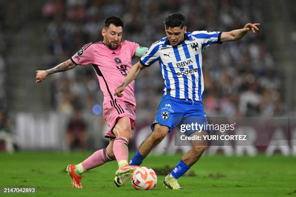 Inter Miami's Argentine forward Lionel Messi and Monterrey's defender Gerardo Arteaga fight for the ball during the Concacaf Champions Cup...