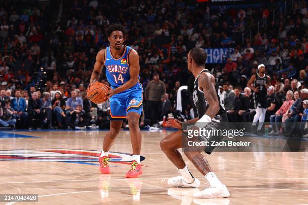 Adam Flagler of the Oklahoma City Thunder handles the ball during the game against the San Antonio Spurs on April 10, 2024 at Paycom Arena in...
