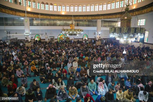 Syrian Muslim worshippers gather to perform the morning prayers at the holiday of Eid al-Fitr, which marks the end of the holy fasting month of...