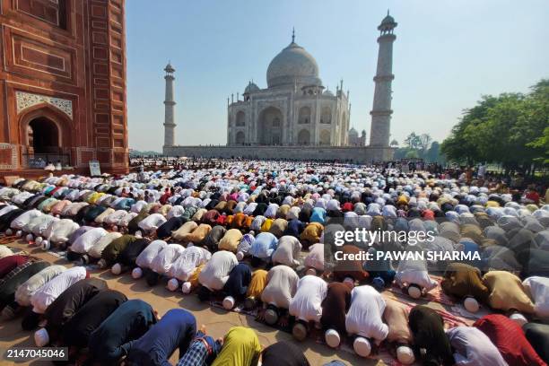 Muslim devotees offer Eid al-Fitr prayers, which marks the end of the holy fasting month of Ramadan, inside the complex of Taj Mahal in Agra on April...