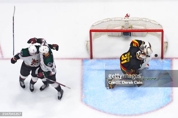 Dylan Guenther of the Arizona Coyotes is congratulated after scoring a goal on Arturs Silovs of the Vancouver Canucks during the third period of...