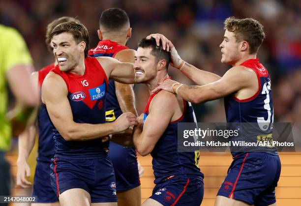 Jack Viney, Alex Neal-Bullen and Kade Chandler of the Demons celebrate during the 2024 AFL Round 05 match between the Melbourne Demons and the...