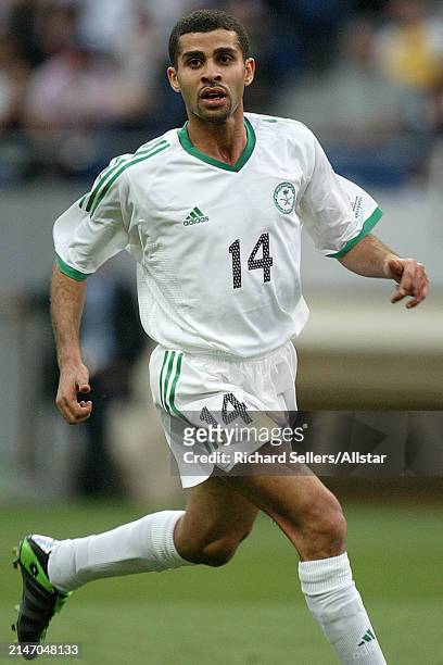 June 6: Abdulaziz Khathran of Saudi Arabia running during the FIFA World Cup Finals 2002 Group E match between Cameroon and Saudi Arabia at Saitama...