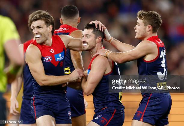 Jack Viney, Alex Neal-Bullen and Kade Chandler of the Demons celebrate during the 2024 AFL Round 05 match between the Melbourne Demons and the...