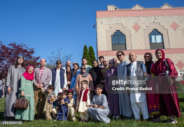 Family poses for a photograph as they gather to perform Eid al-Fitr prayer at the Dar Alnoor Islamic Community Center. Muslims of different...