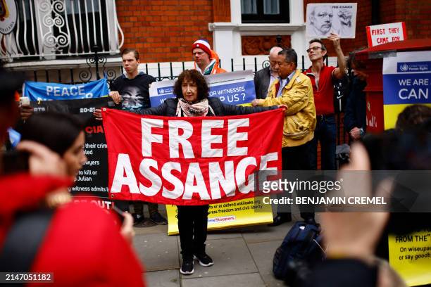 Supporters of WikiLeaks founder Julian Assange display banners at a demonstration outside the Ecuadorian Embassy in London on April 11 on the fifth...