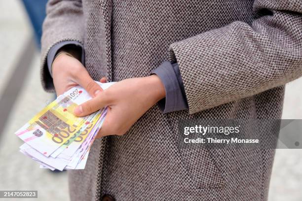 An Ukrainian from the diaspora shows blody Euro banknotes in front of the Belgium-based financial services company Euroclear to advocate for Western...