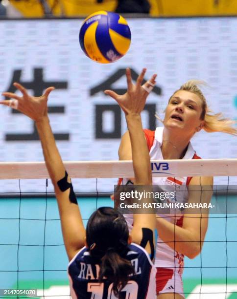 Poland's Malgorzata Glinka-Mogentale spikes the ball to Paola Ramirez Vargas of Costa Rica during the first round of the world woman's volleyball...