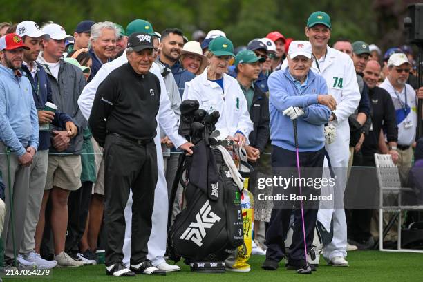 Honorary Starters Jack Nicklaus and Gary Player of South Africa wait with their caddies on the first tee for the Honorary starters ceremony during...